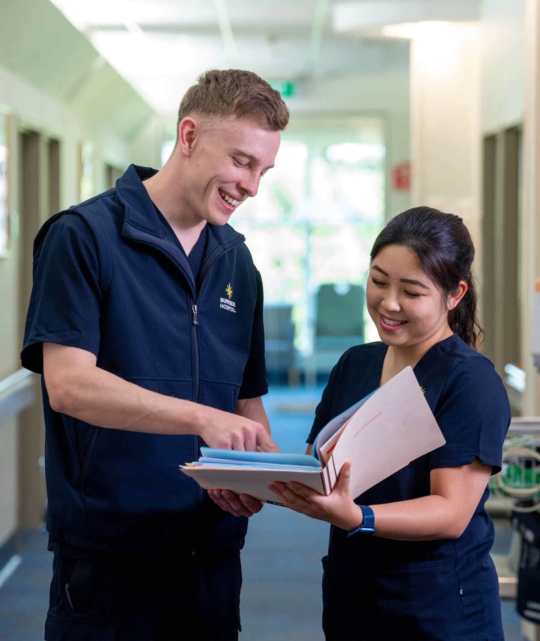 Two Burnside Hospital team members collaborating in the hospital