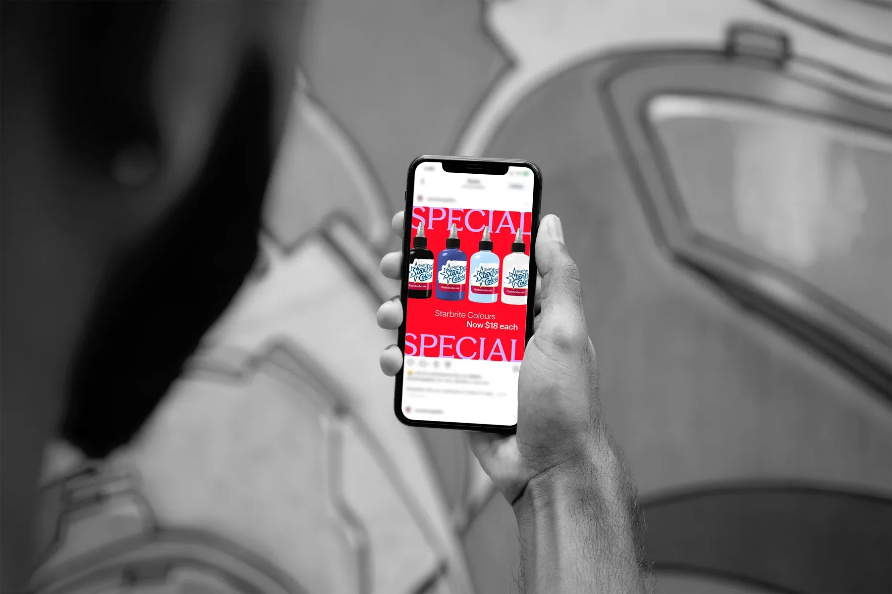 A person viewing a red Protat ink promotion on Instagram in a tattoo studio