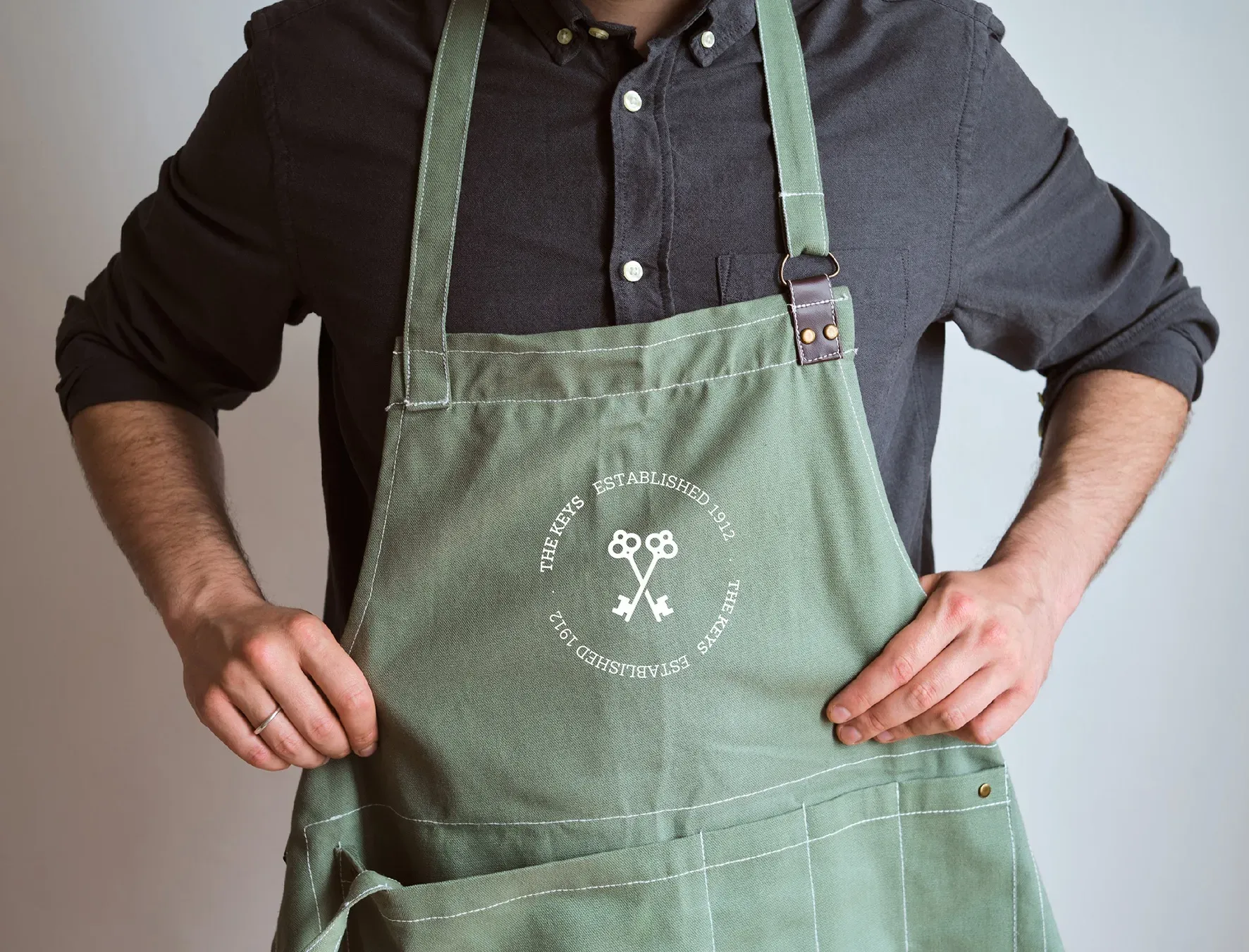 The Keys identity embroidered on a hospitality apron