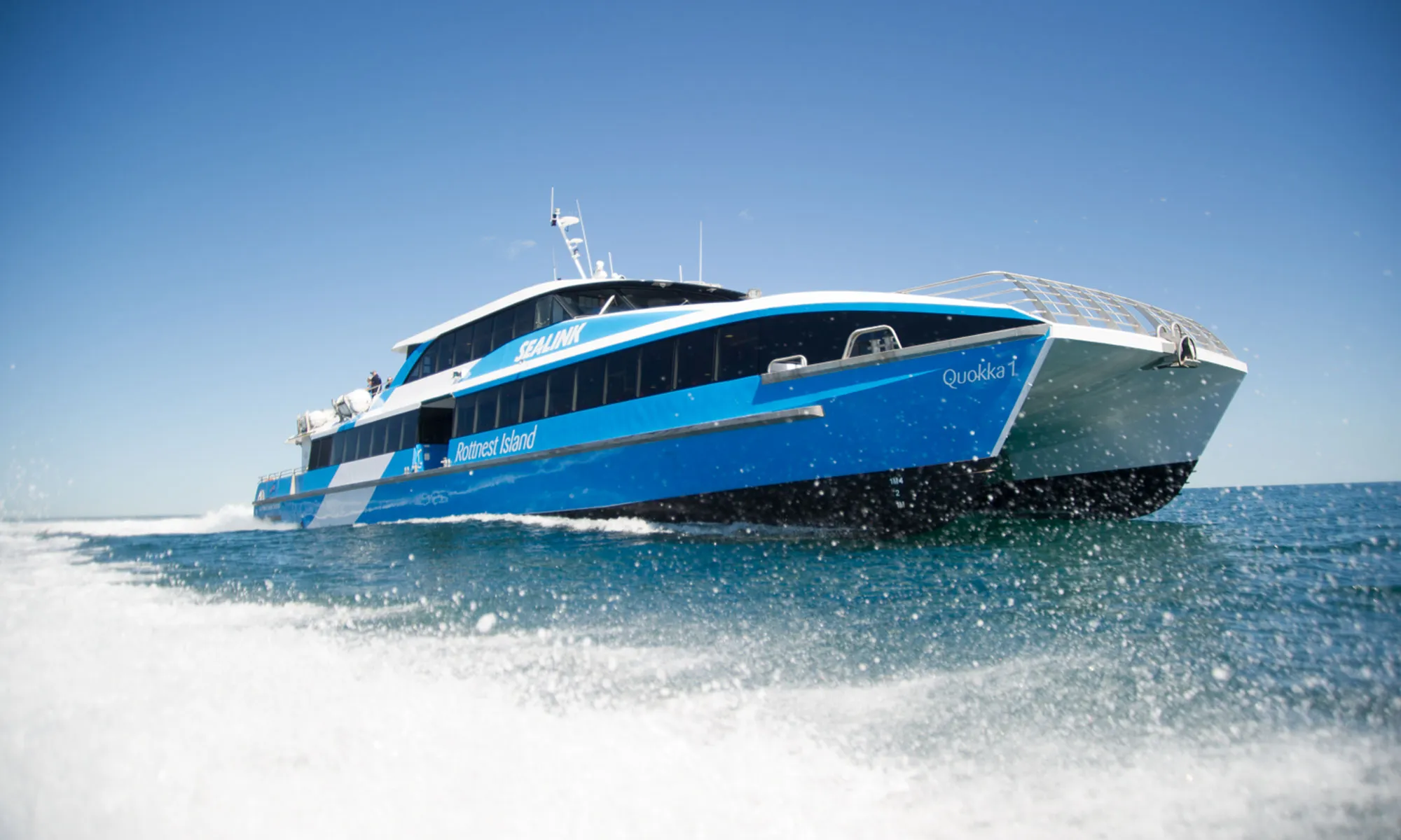 SeaLink ferry travelling at speed across blue water